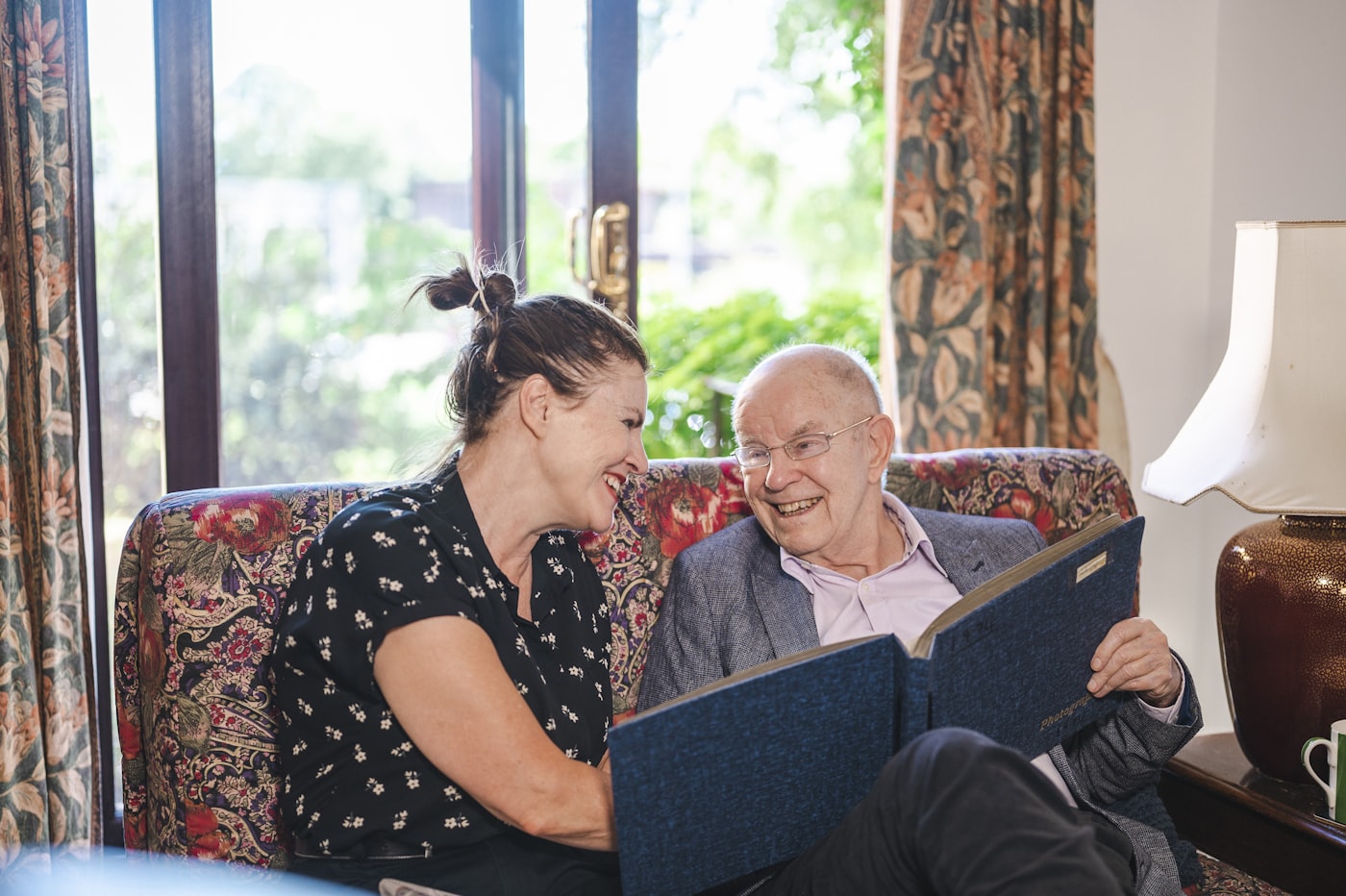 A Braewood caregiver and an older adult talking together at home