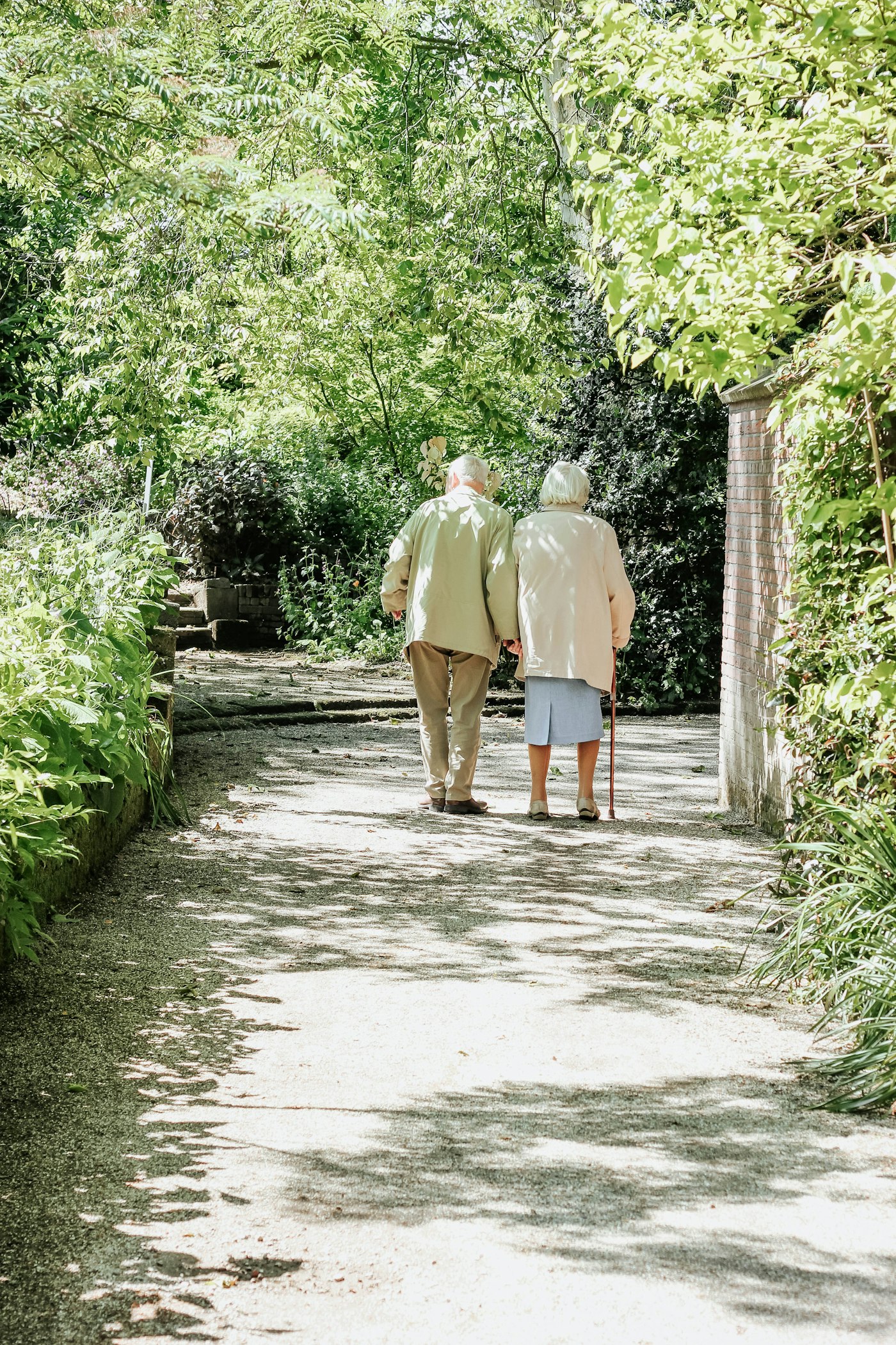 Older adult walking outdoors with support, regaining independence
